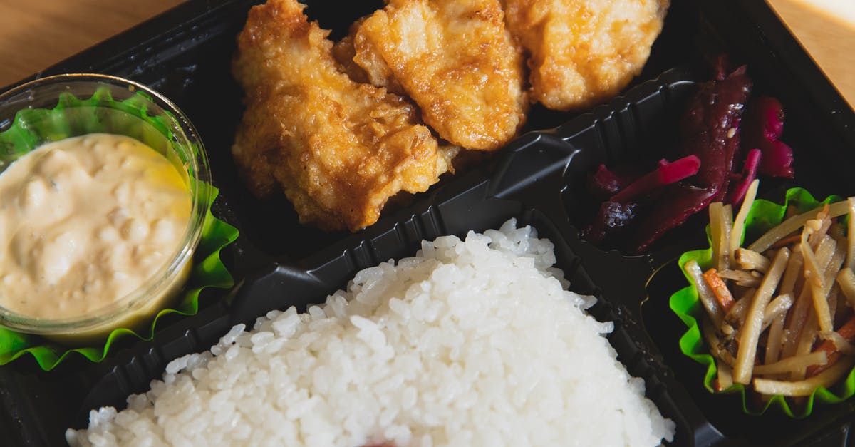 Why is it uncommon to fill airliners from both ends? - From above of plastic container with fried chicken and rice with sauce near sauce and sliced vegetables Why is it uncommon to fill airliners from both ends? - From above of plastic container with fried chicken and rice with sauce near sauce and sliced vegetables