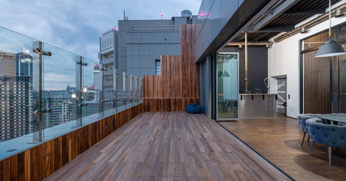 Why is the bathroom's light switch outside the room in some countries? - Empty spacious terrace with wooden floor and walls placed in modern apartment in cloudy day Why is the bathroom's light switch outside the room in some countries? - Empty spacious terrace with wooden floor and walls placed in modern apartment in cloudy day
