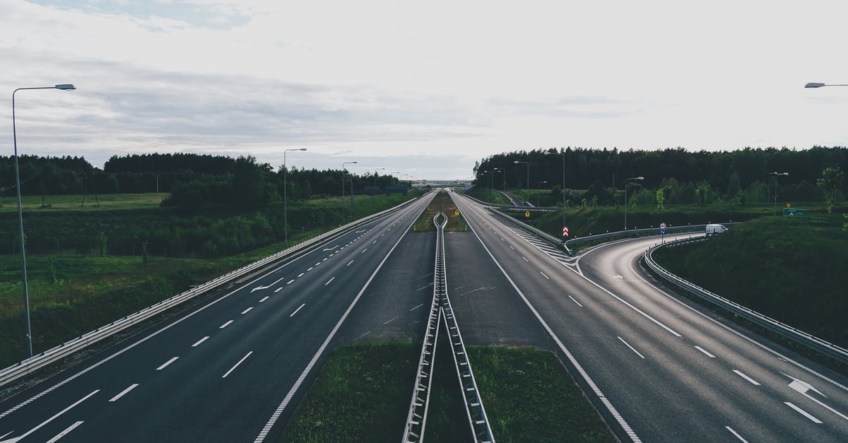 Why is the flight path from Taipei to Tianjin not a straight line? [closed] - From above of modern empty highway junction among green fields with trees against cloudy gray sky