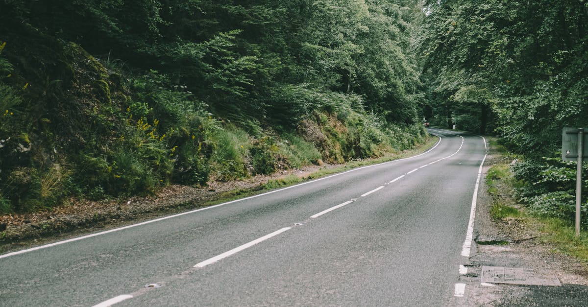 Why is the flight path from Taipei to Tianjin not a straight line? [closed] - Narrow straight asphalt highway surrounded with tall green trees with lush foliage growing in forest in countryside on summer day