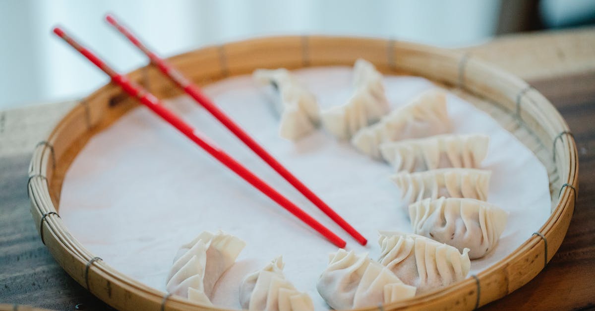 Why is there no tray table in the front row of airlines? - Raw dumplings with chopsticks on bamboo plate Why is there no tray table in the front row of airlines? - Raw dumplings with chopsticks on bamboo plate