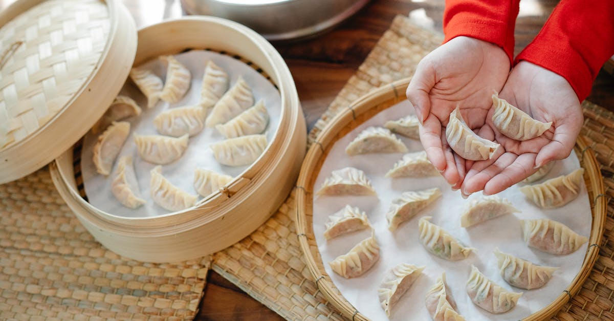 Why is there no tray table in the front row of airlines? - High angle of crop anonymous female showing raw dumplings over table with bamboo steamer in house Why is there no tray table in the front row of airlines? - High angle of crop anonymous female showing raw dumplings over table with bamboo steamer in house