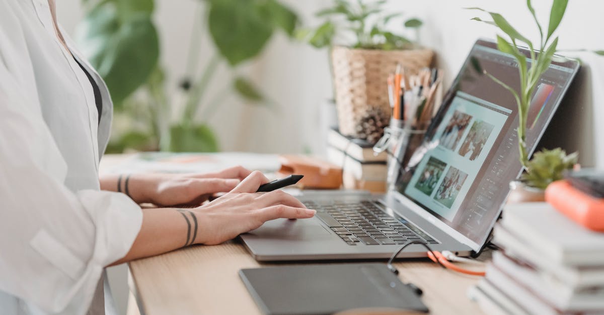 Why was a photo taken of my passport? - Woman working retouching photo on laptop at convenient workplace Why was a photo taken of my passport? - Woman working retouching photo on laptop at convenient workplace