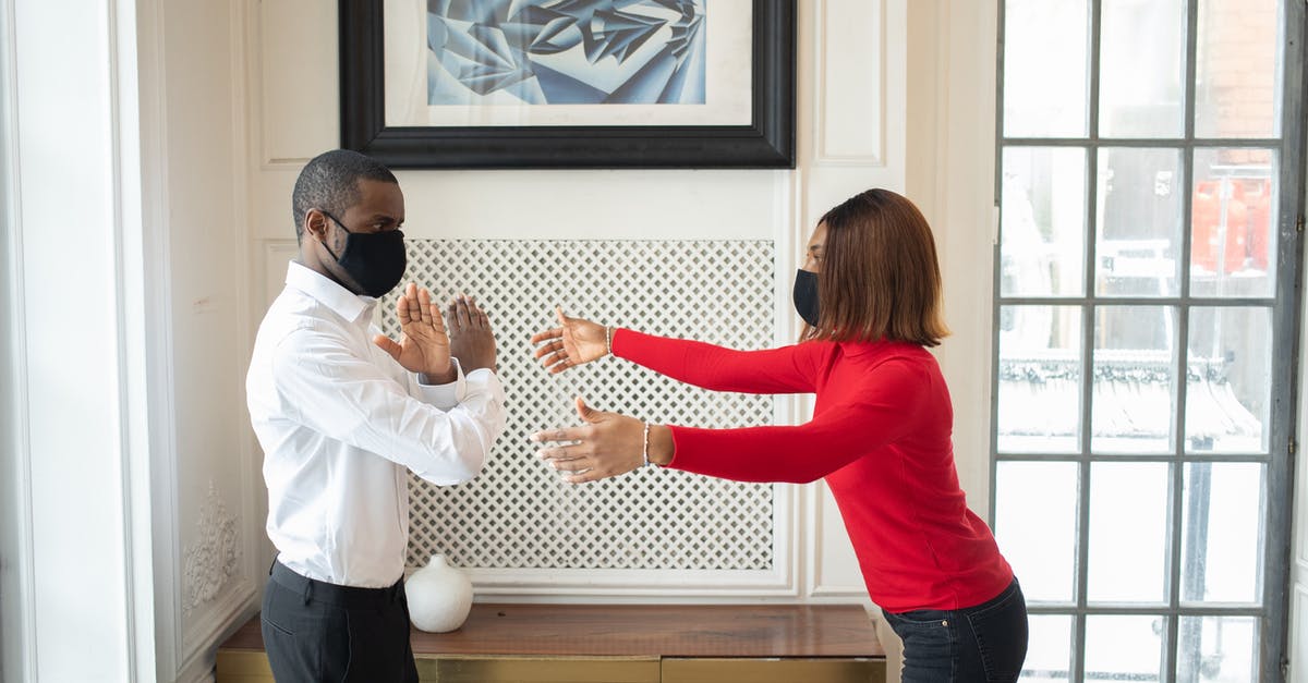 Why was my colleague refused a US B1 visa? - Black boss in fabric mask showing no gesture against partner Why was my colleague refused a US B1 visa? - Black boss in fabric mask showing no gesture against partner