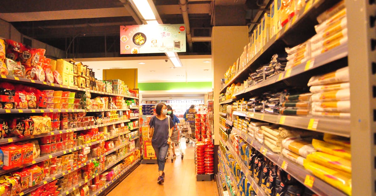 Why would I choose full service carrier instead of a low-cost one? - Female customer choosing products in market