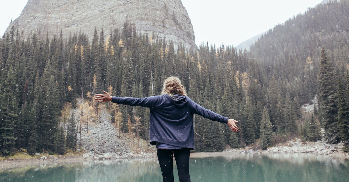 WildLife Tourist Destination in France - Woman with arms outstretched standing on coast of lake WildLife Tourist Destination in France - Woman with arms outstretched standing on coast of lake