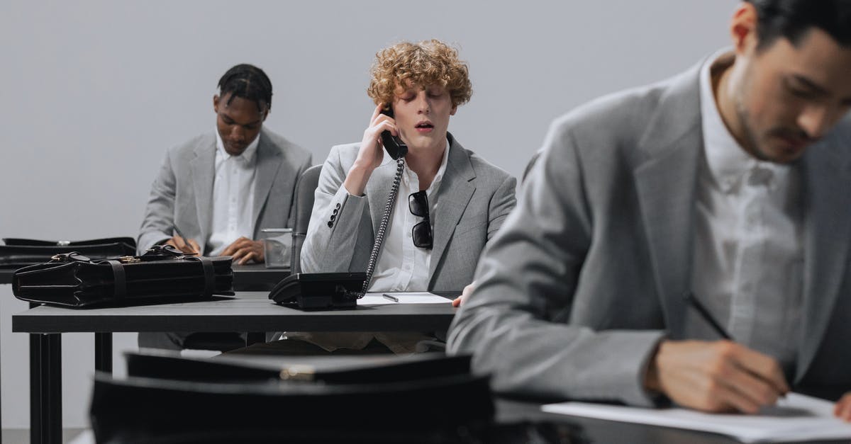 Will a smartcard work alongside a railcard? - Man in Gray Suit Jacket Talking to Man in Gray Suit Will a smartcard work alongside a railcard? - Man in Gray Suit Jacket Talking to Man in Gray Suit