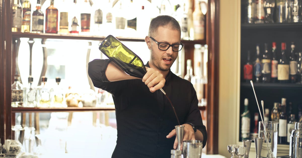 Will bringing your own bottle of wine to a restaurant in France cause bad service? - Barman preparing cocktail at counter Will bringing your own bottle of wine to a restaurant in France cause bad service? - Barman preparing cocktail at counter