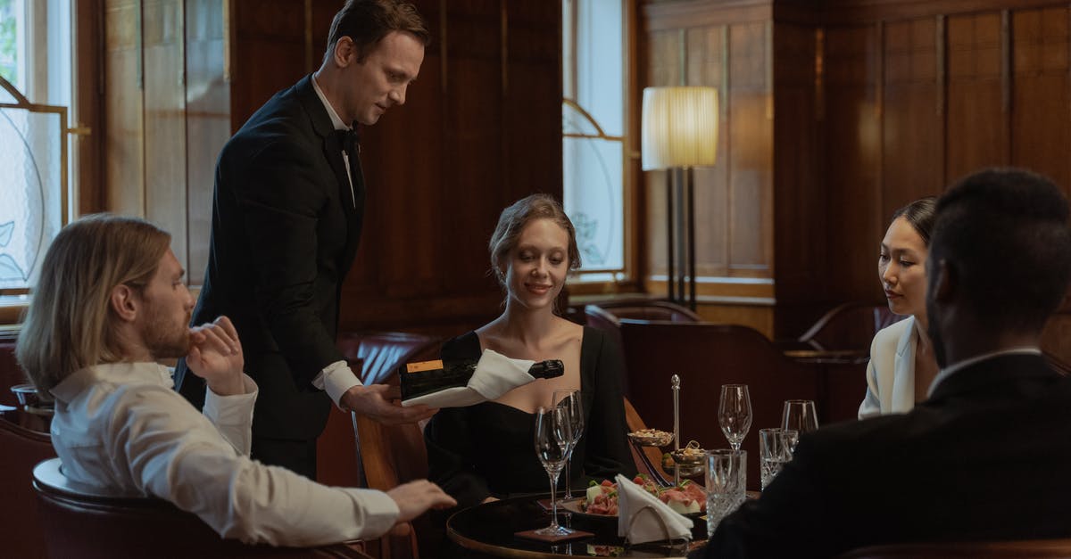 Will bringing your own bottle of wine to a restaurant in France cause bad service? - Photo of a Waiter Pouring Wine into Glasses Will bringing your own bottle of wine to a restaurant in France cause bad service? - Photo of a Waiter Pouring Wine into Glasses