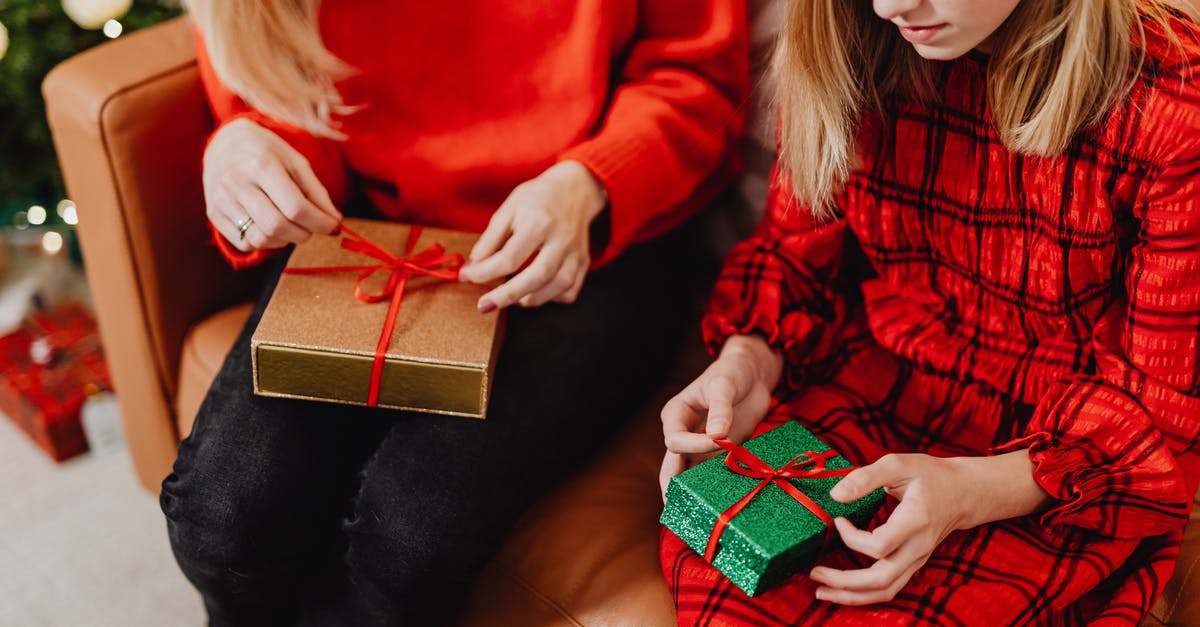 Will businesses be open on Christmas in Mexicali? - Woman in Red Long Sleeve Shirt Holding Black and Red Gift Box Will businesses be open on Christmas in Mexicali? - Woman in Red Long Sleeve Shirt Holding Black and Red Gift Box