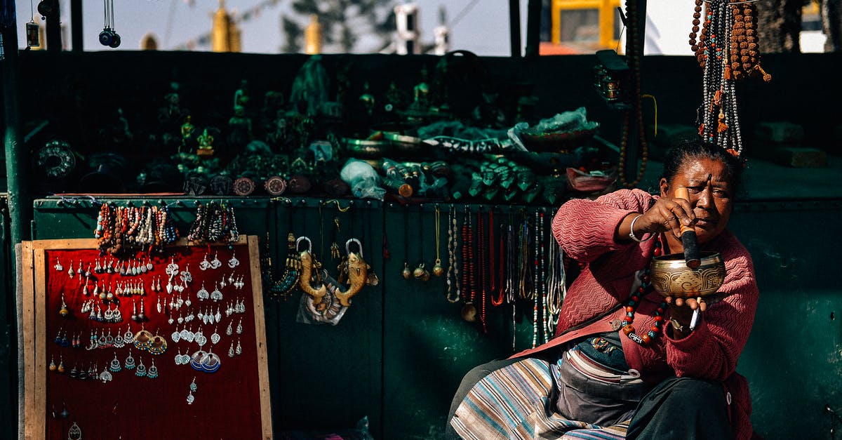 Will connecting my wallet to my belt loop deter or attract pickpockets? - Serious mature overweight ethnic female vendor sitting with pounder and pestle near stands with collection of accessories in city and looking away Will connecting my wallet to my belt loop deter or attract pickpockets? - Serious mature overweight ethnic female vendor sitting with pounder and pestle near stands with collection of accessories in city and looking away
