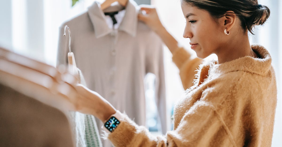Will I be able to purchase an Arafat T-shirt in Palestine/Israel? - Crop focused ethnic female in casual clothes choosing apparel while standing near rack in boutique