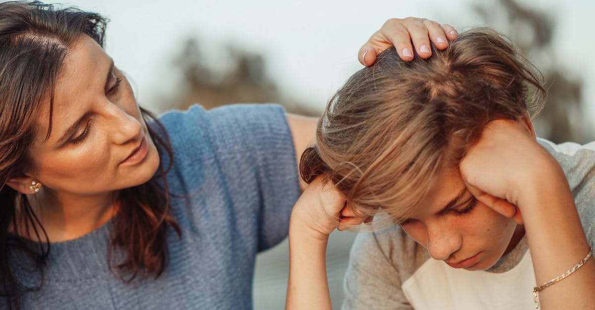 Will I encounter any problems as a recognizable Jew in India? - Woman in Blue Shirt Talking to a Young Man in White Shirt Will I encounter any problems as a recognizable Jew in India? - Woman in Blue Shirt Talking to a Young Man in White Shirt