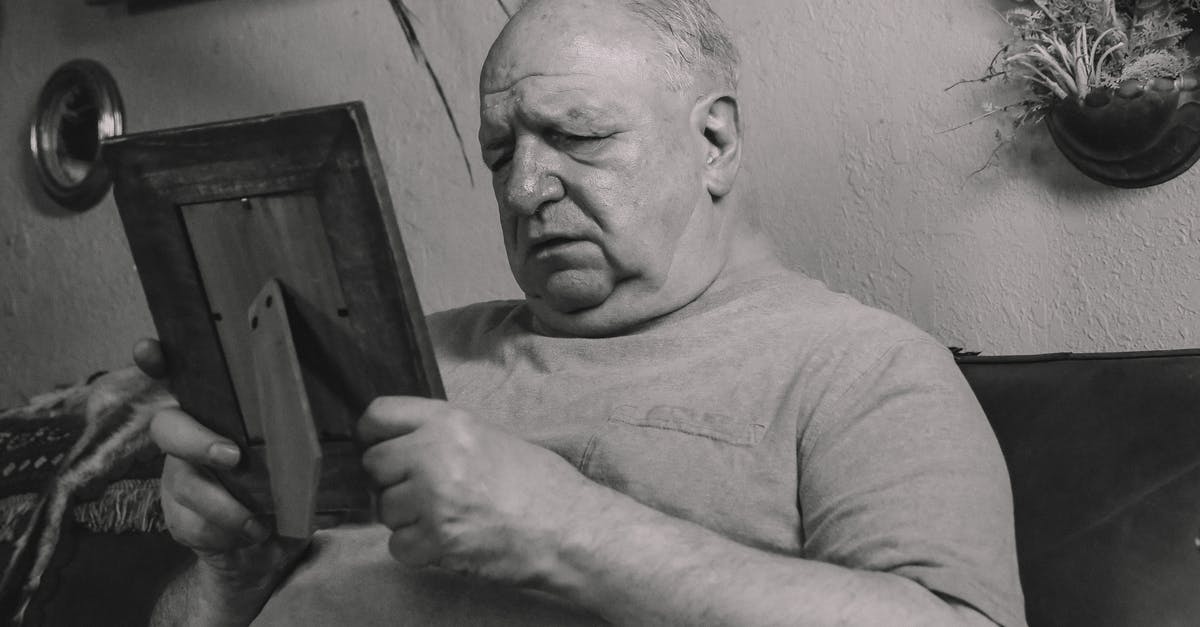 Will I encounter any problems as a recognizable Jew in India? - A Grayscale Photo of an Elderly Man Holding a Wooden Frame Will I encounter any problems as a recognizable Jew in India? - A Grayscale Photo of an Elderly Man Holding a Wooden Frame