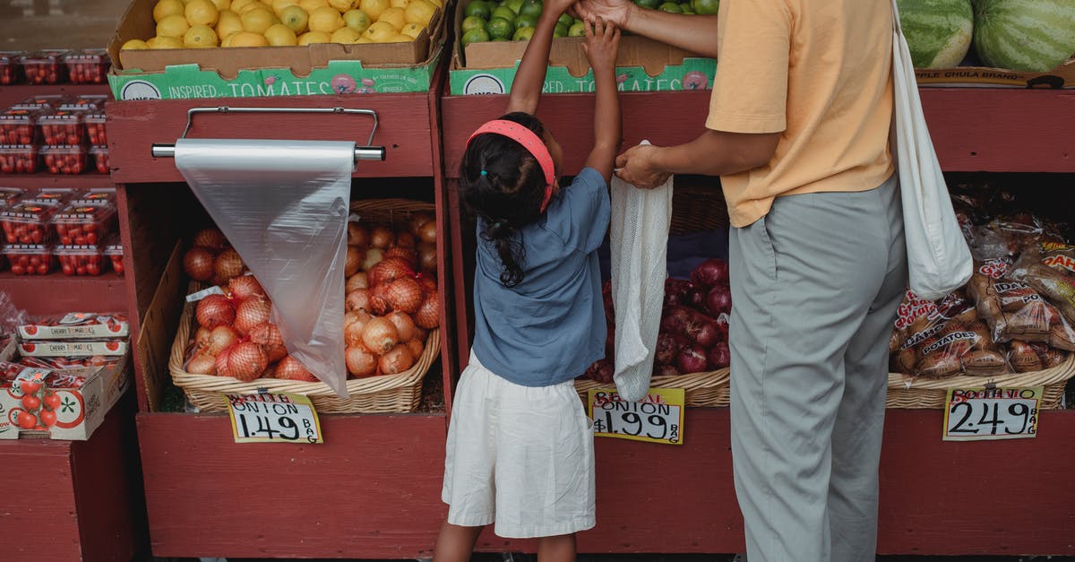 Will I have to clear Customs, pick up my bag and recheck it when flying BFS-EWR-YVR? [duplicate] - Ethnic woman choosing fruits with daughter in market
