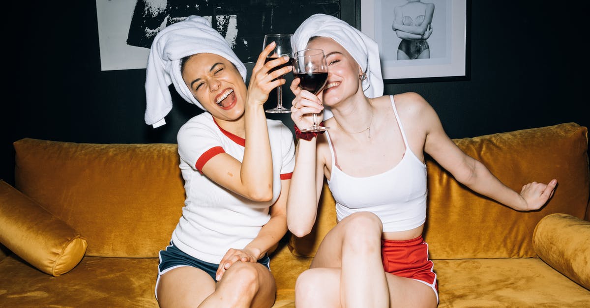 Will I have to pay extra for a seat if no standard are left? - Two Young Women Sitting on a Yellow Sofa While Holding a Wine Glass With Red Wine Will I have to pay extra for a seat if no standard are left? - Two Young Women Sitting on a Yellow Sofa While Holding a Wine Glass With Red Wine