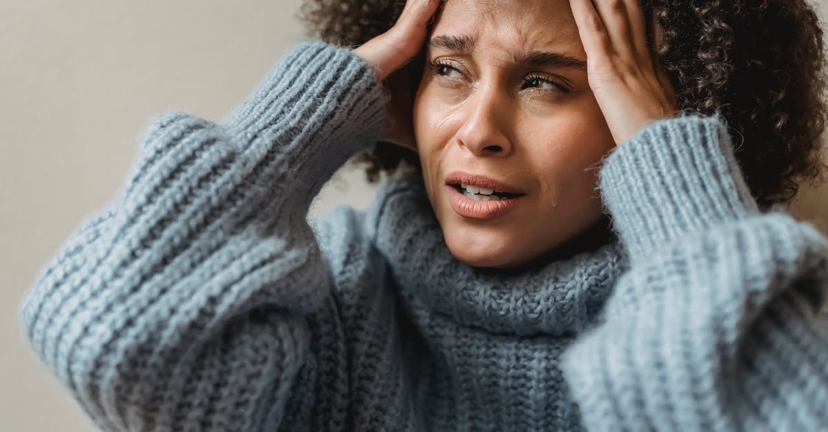 Will I have trouble at US Immigration if my appearance differes from my visa photo? - Worried African American female with brown curly hair crying and touching head against light wall Will I have trouble at US Immigration if my appearance differes from my visa photo? - Worried African American female with brown curly hair crying and touching head against light wall