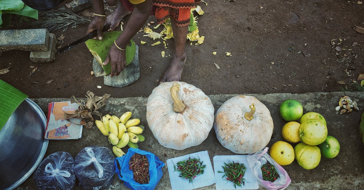 will I need to pick up & recheck bags with layover in Calgary? [closed] - Woman with Stacked Fruit and Vegetables