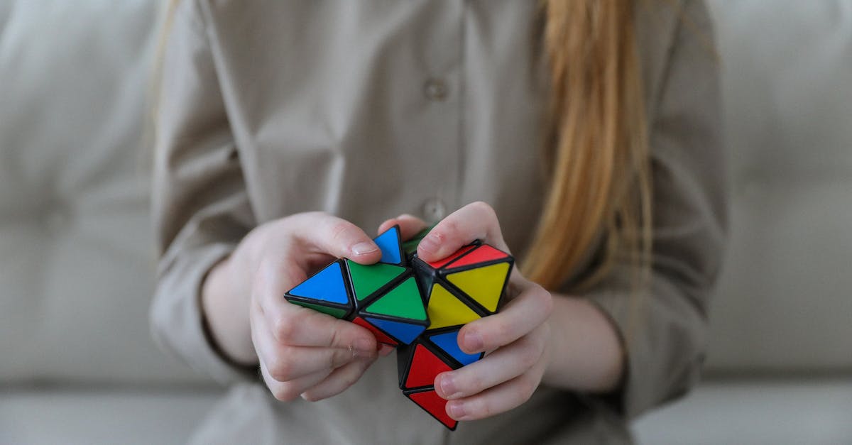 Will knowledge of Yiddish be useful traveling in Israel? - Crop anonymous girl demonstrating and solving colorful puzzle with triangles in soft focus Will knowledge of Yiddish be useful traveling in Israel? - Crop anonymous girl demonstrating and solving colorful puzzle with triangles in soft focus
