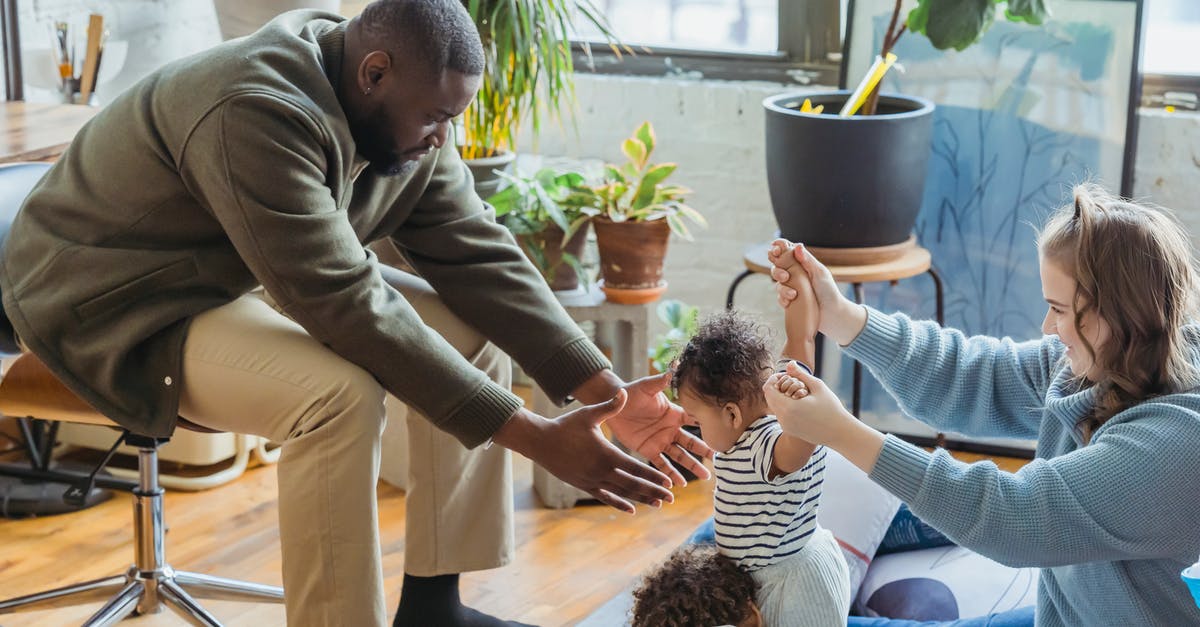 Will mention of a previously undisclosed relative, who will now invite me to the UK, help me to obtain a visa? [closed] - Diverse parents supporting infant learning walking near brother while spending time together at home