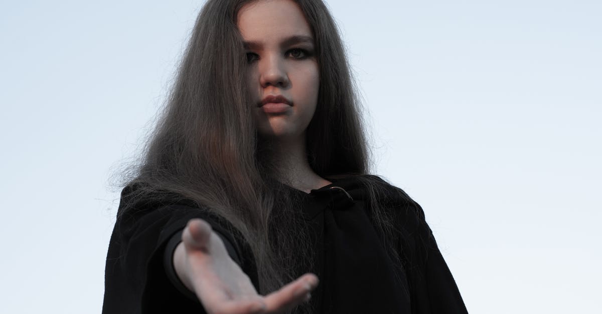 Will mention of a previously undisclosed relative, who will now invite me to the UK, help me to obtain a visa? [closed] - Calm wistful woman in black cloak offering hand