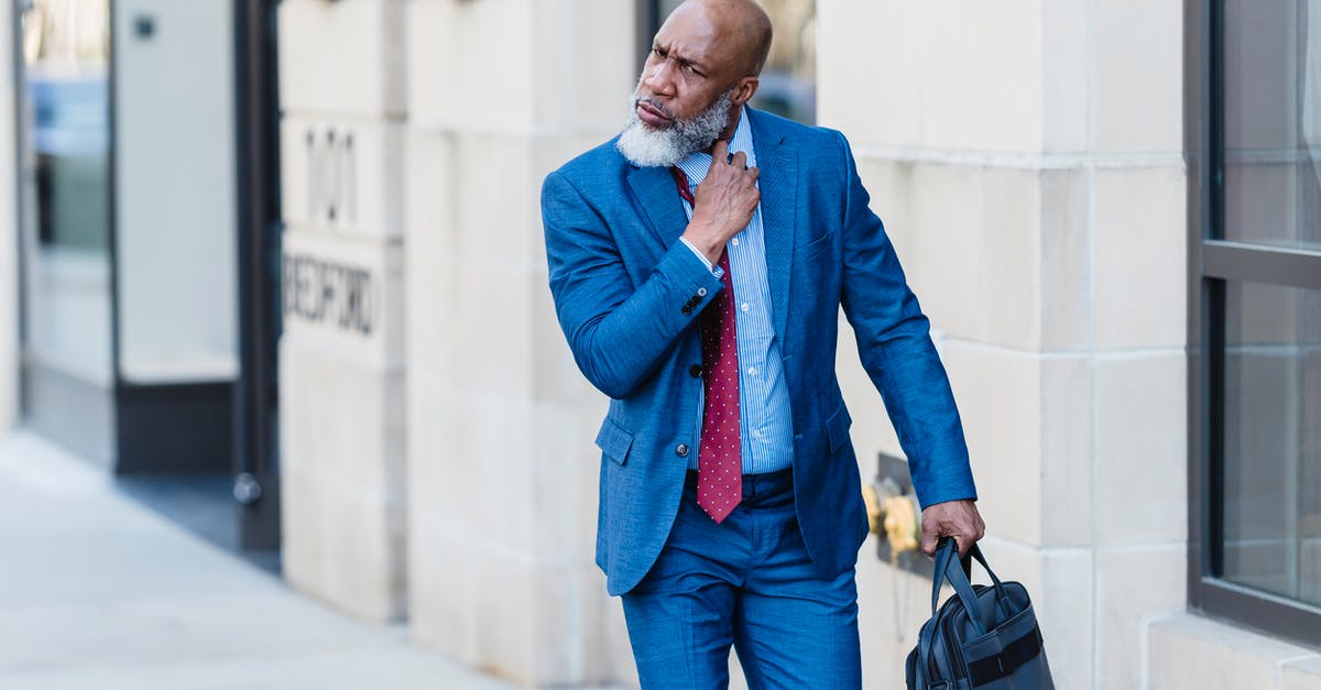 Will my B1/B2 visa become invalid if I quit my job? - Serious black businessman walking on street Will my B1/B2 visa become invalid if I quit my job? - Serious black businessman walking on street