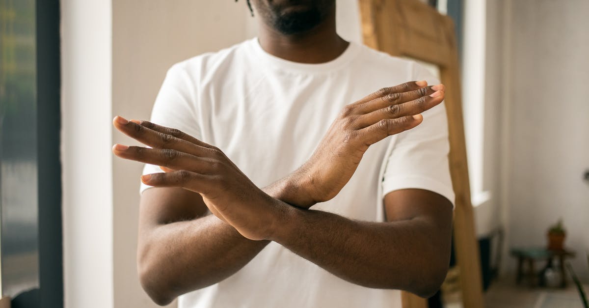 Will my visa be refused if I didn't sign the declaration page? [closed] - Crop unrecognizable bearded African American male in white t shirt demonstrating no gesture with hands while standing in light room