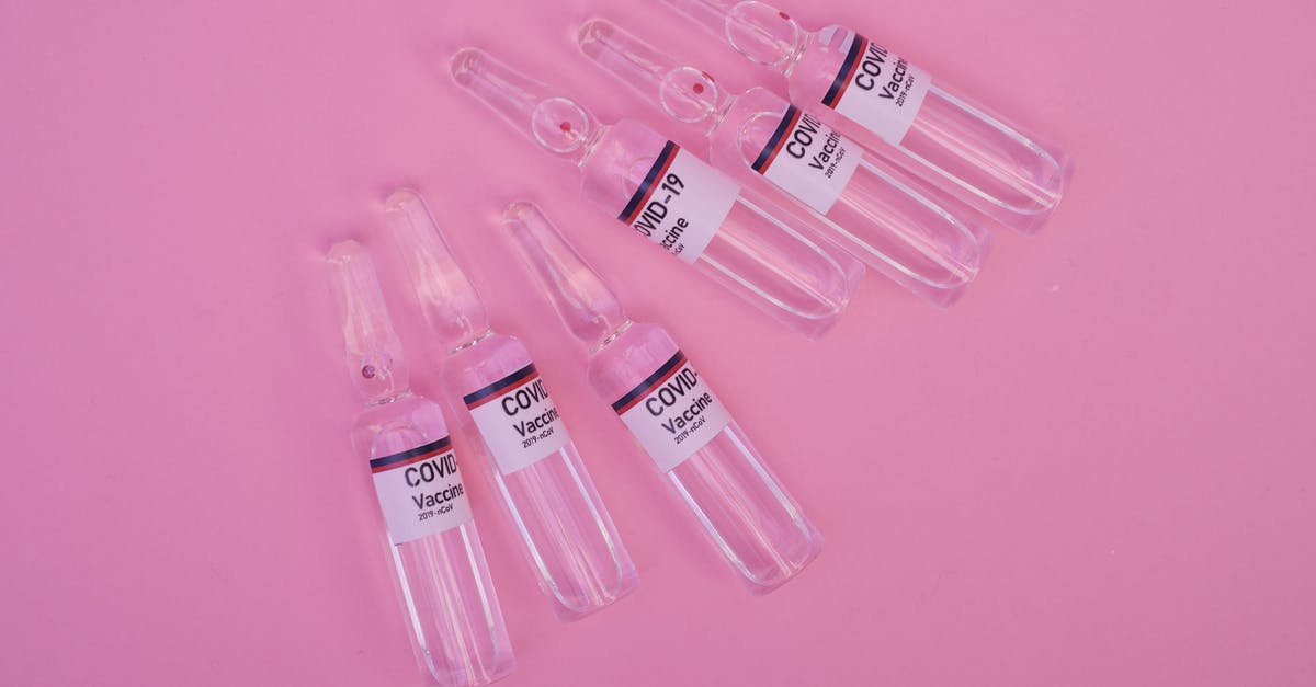Will putting prescription bottles in a ziploc bag minimize the risk of TSA agents checking it? [closed] - Top view set of sealed glass ampoules with COVID 19 vaccine arranged on pink surface
