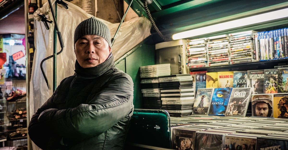 Will the relocated Tsukiji have a larger auction and market areas? - Asian man selling DVD discs Will the relocated Tsukiji have a larger auction and market areas? - Asian man selling DVD discs