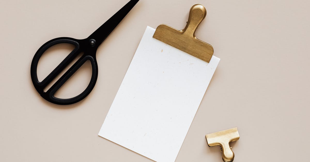 Within Dubai, is duty-free gold cheaper for comparable quality from the local Souk? [closed] - Top view of smal paper clip placed on beige surface near clipboard with gold clip and modern black scissors