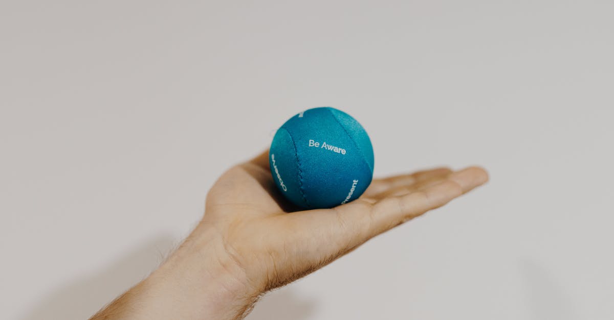 Wizz Air hand luggage size - Crop sportsman showing therapy ball on light background Wizz Air hand luggage size - Crop sportsman showing therapy ball on light background