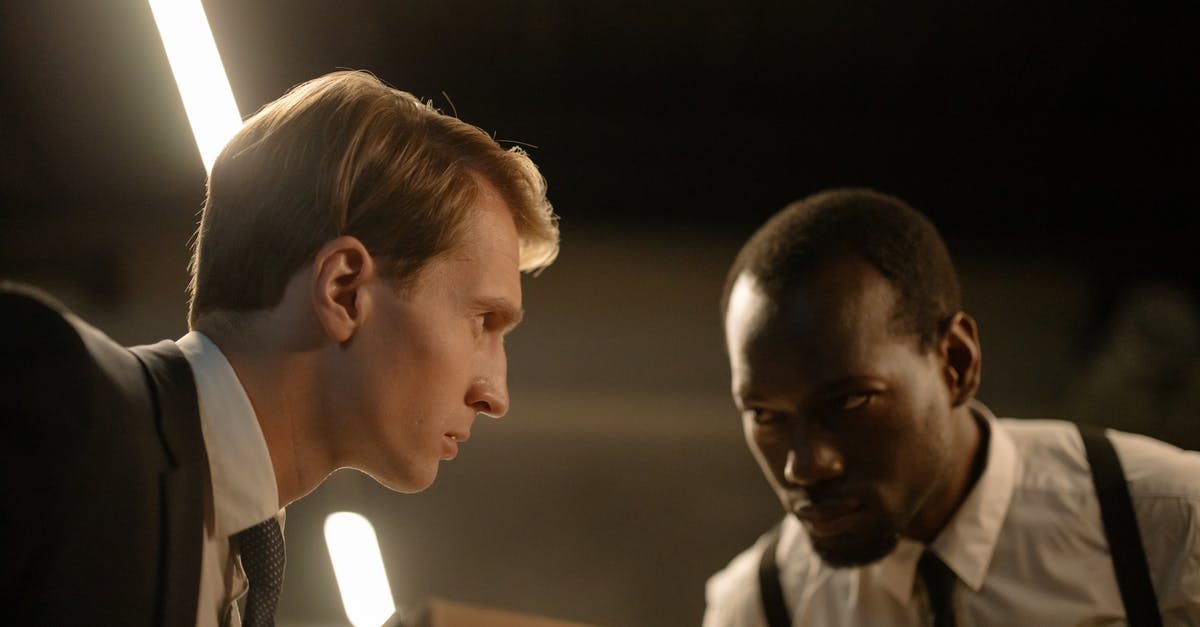 Working for one EU country and living in the other [closed] - Close-Up Shot of Two Investigators Looking at Each Other