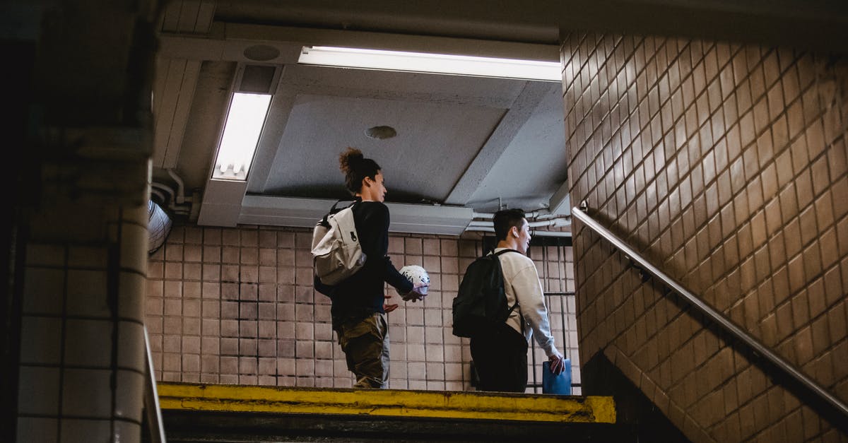 World's longest purpose-built pedestrian tunnel? - Young men walking on metro staircase World's longest purpose-built pedestrian tunnel? - Young men walking on metro staircase