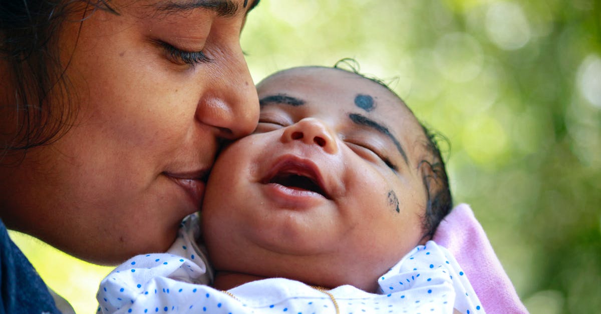 Would a parent's citizenship affect a UK visa application for their children? [closed] - Close-Up Photo of Mother Kissing Her Baby