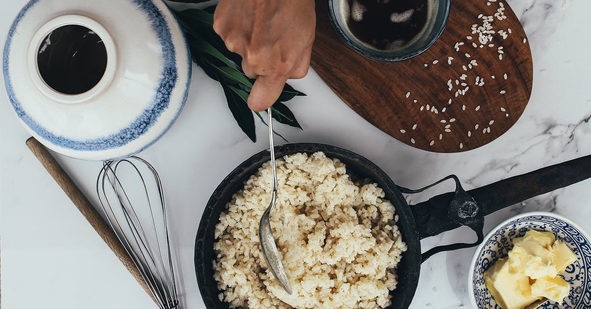 Would it be ok to eat rice using a spoon in front of Westerners? - Person Holding Stainless Steel Fork and Knife Slicing Food on Brown Wooden Chopping Board Would it be ok to eat rice using a spoon in front of Westerners? - Person Holding Stainless Steel Fork and Knife Slicing Food on Brown Wooden Chopping Board