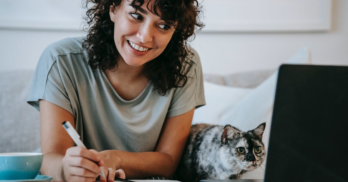 Would taking my used laptop to South Africa attract an import duty? - Crop young positive female smiling and taking notes in organizer while cat watching on netbook at table at home Would taking my used laptop to South Africa attract an import duty? - Crop young positive female smiling and taking notes in organizer while cat watching on netbook at table at home