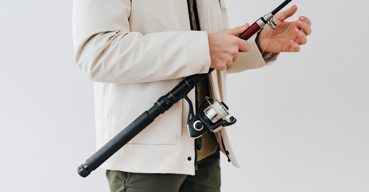 Would you have to remove your jacket for the X-ray machine if you're not wearing anything underneath? - Person Wearing White Jacket Holding a Black Fishing Rod Would you have to remove your jacket for the X-ray machine if you're not wearing anything underneath? - Person Wearing White Jacket Holding a Black Fishing Rod