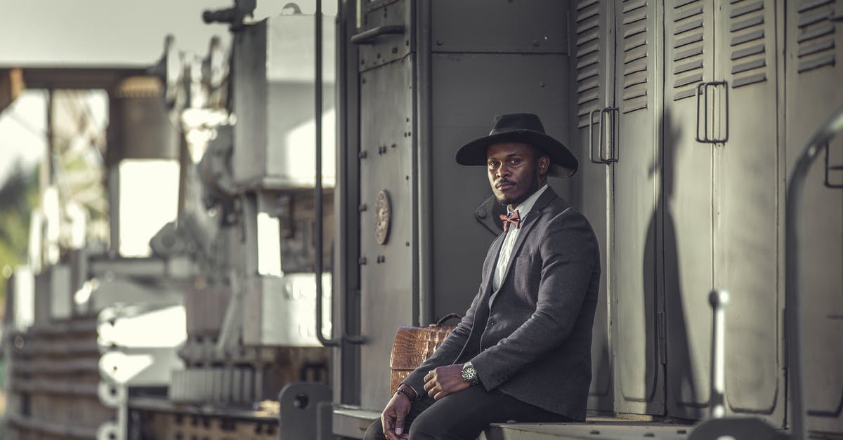 Zagreb - Belgrade train schedules - Elegant Man in Suit Posing near Train Zagreb - Belgrade train schedules - Elegant Man in Suit Posing near Train